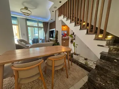 a dining room with a wooden table and chairs at Luxury Smart Home- Villa Duplex in Hurghada