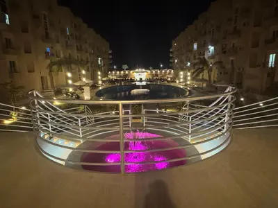 a fountain in the middle of a city at night at Luxury Smart Home- Villa Duplex in Hurghada