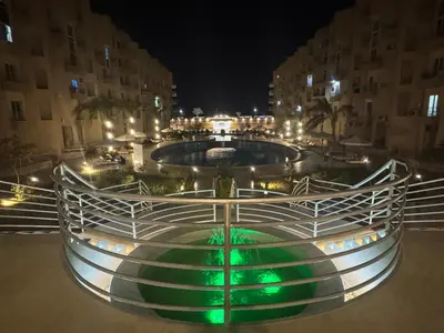 a pool in the middle of a city at night at Luxury Smart Home- Villa Duplex in Hurghada