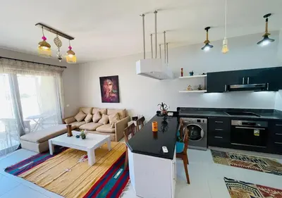 a living room with a couch and a table at Cozy 3 Bedrooms Apartment at Cyan El-Gouna in Hurghada