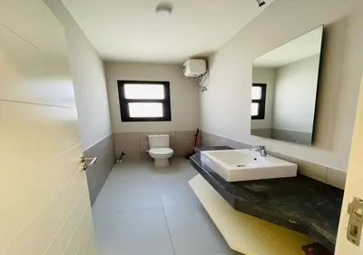 a bathroom with a sink and a toilet at Cozy 3 Bedrooms Apartment at Cyan El-Gouna in Hurghada