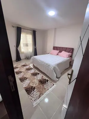 a bedroom with a bed and a rug at Tiba gollden resort in Hurghada
