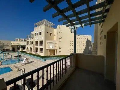 a balcony with a view of a pool and buildings at Gouna Luxuy Condo Hotel in El Gouna