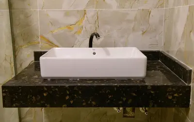 a white sink on a black counter in a bathroom at Eyaru Palace Nile View in Luxor