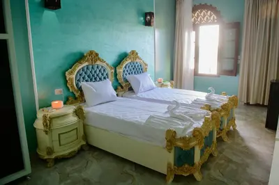 a bedroom with a bed with two swans on it at Eyaru Palace Nile View in Luxor