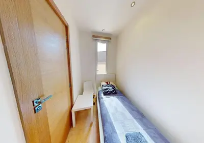 a small room with a bed and a door at Cozy 2 Bedroom-WS3 at SCARAB Elgouna in Hurghada