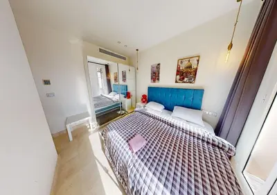 a bedroom with a large bed and a mirror at Cozy 2 Bedroom-WS3 at SCARAB Elgouna in Hurghada