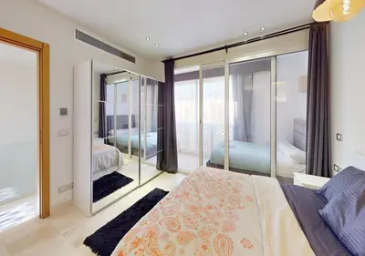 a bedroom with a bed and a large mirror at Cozy 2 Bedroom-WS3 at SCARAB Elgouna in Hurghada