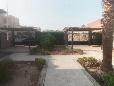 a courtyard with a pavilion and a tree at Happiness Villa Majawish, close to the city center in Hurghada