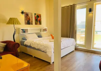 a small bedroom with a bed and a window at Warm Studio MB1 at Marina El Gouna in Hurghada