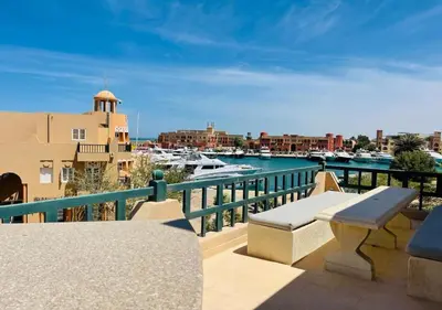 a balcony with a view of a harbor with boats at Warm Studio MB1 at Marina El Gouna in Hurghada