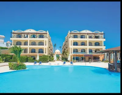 a large swimming pool in front of a building at Palm Beach Piazza Beachfront lovely Apartment in Hurghada
