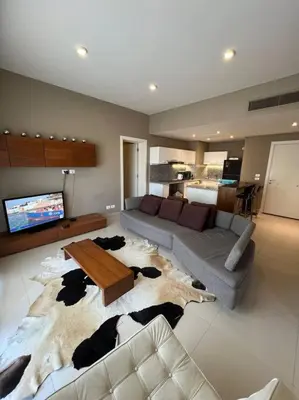 a living room with a couch and a cow rug at Modern Apartment Abutig Marina in Hurghada