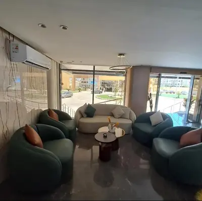 a living room with couches and a table at Tiba gollden resort in Hurghada