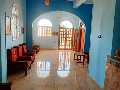 a waiting room with chairs and a blue wall at Amenophis Hotel in Luxor