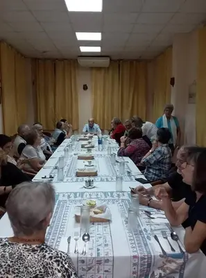 a group of people sitting around a long table at Amenophis Hotel in Luxor