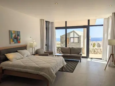a bedroom with a large bed and a large window at Sea View Studio in Soma Bay With Free Beach & Pool in Hurghada