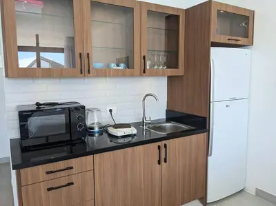 a kitchen with a white refrigerator and a microwave at Sea View Studio in Soma Bay With Free Beach & Pool in Hurghada