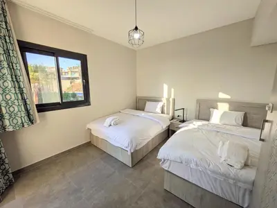a bedroom with two beds and a window at 2BR Somabay Twin Villa in Mesca Near Beach & Pools in Hurghada