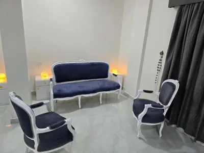 a room with two chairs and a blue couch at siriuspalaceluxor in Al Karnak