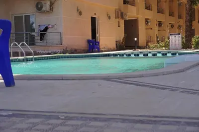 a swimming pool in front of a building at Casablanca Beach - Panoramic Sea view Apartment in Hurghada
