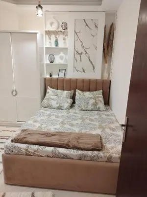 a bedroom with a large bed with white walls at Casablanca Beach - Panoramic Sea view Apartment in Hurghada