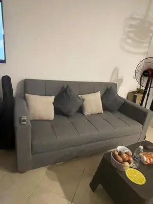 a gray couch in a living room with a table at Diamond resort compound in Hurghada