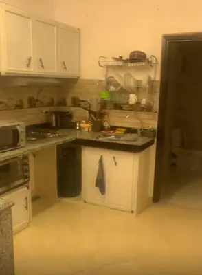 a kitchen with white cabinets and a counter top at Diamond resort compound in Hurghada