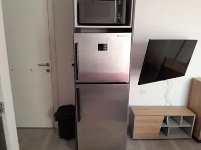 a refrigerator with a microwave on top of it at Cozy Studio in Hurghada bali theme resort in Hurghada