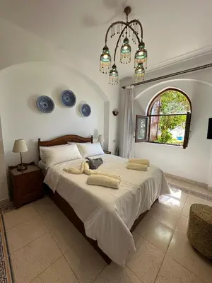 a bedroom with a large bed with towels on it at 2 Bedroom Ground Floor New Nubia - 2 minutes walk to marina Abu Tig in Hurghada