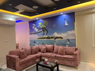 a living room with a couch in front of a mural at Dream apartment1 in Hurghada