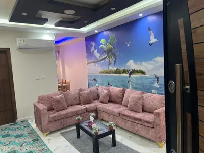 a living room with a couch in front of a mural at Dream apartment1 in Hurghada