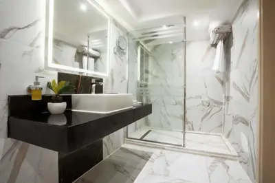 a bathroom with a sink and a glass shower at Orient Sun Times Nile Cruise-Every Monday from Luxor for 04 & 07 Nights - Every Friday From Aswan for 03 Nights in Luxor
