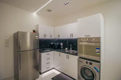 a kitchen with a stainless steel refrigerator and a dishwasher at La Prestigia in Hurghada