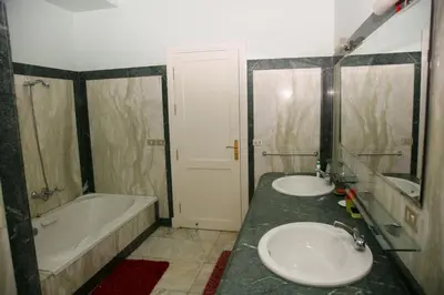 a bathroom with two sinks and a bath tub at White villa phase2 - Elgouna 5BD in Hurghada