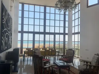 a room with a table and chairs and a large window at White villa phase2 - Elgouna 5BD in Hurghada