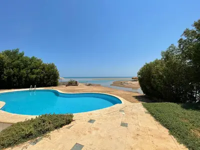 a swimming pool with the ocean in the background at White villa phase2 - Elgouna 5BD in Hurghada