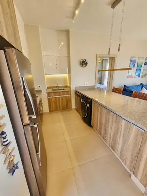 a kitchen with a stainless steel refrigerator and a sink at Sunrise to Sunset Rooftop Panorama - El Gouna Shedwan in Hurghada