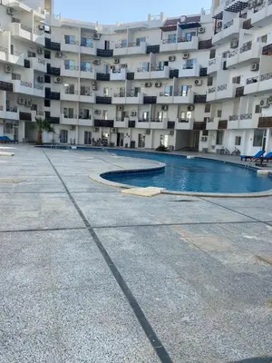a large apartment building with a swimming pool in front of it at Tiba view Hurghada in El Gouna