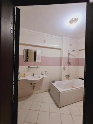 a bathroom with a tub and a sink at Nile Bride in Naj‘ al ‘Amrāb