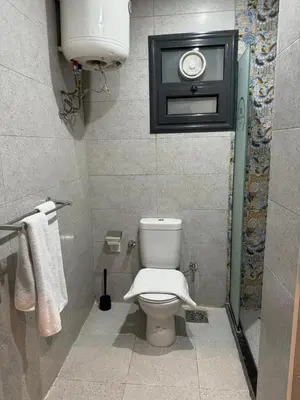 a bathroom with a toilet with a white towel at Nuba Nile Hotel in Aswan