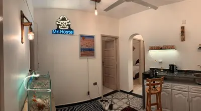 a bathroom with a fish tank on the wall at MRHostel Luxor in Luxor