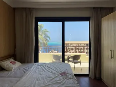 a bedroom with a bed and a view of the ocean at Studil for rent 206 hill in Hurghada