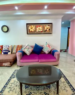 a living room with a purple couch and a table at aswan view 3 bedrooms in Aswan