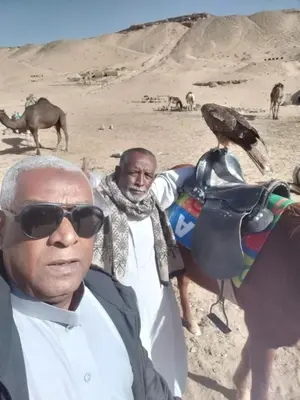a man standing next to a bird on a horse at Mourad morsy مراد in Najâ€˜ al MadÄbb