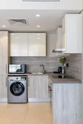 a kitchen with a washing machine and a sink at Delightful Gateway in Mangroovy in Hurghada