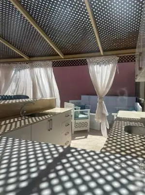 a room with two beds and a curtain at Sunny Sea View Studio Marina on private roof in Hurghada