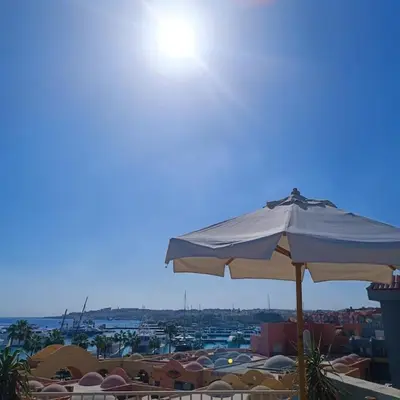 a white umbrella sitting on top of a building at Sunny Sea View Studio Marina on private roof in Hurghada