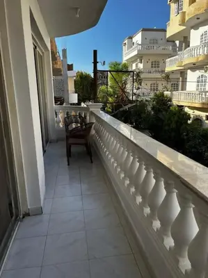 a balcony with a chair on a building at Sekhmet Appartement 2 chambres in Luxor