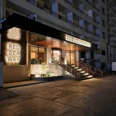 a building with a red sea way sign at night at Tiba Golden Resort apartment 45 with beach access in Hurghada